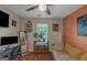 Stylish bedroom with a workstation, a loveseat, an accent wall, and plenty of natural light at 3823 Rock Hollow Ct, Conley, GA 30288
