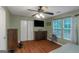 Spacious bedroom features hardwood floors, ceiling fan, and lots of natural light with two large windows at 3823 Rock Hollow Ct, Conley, GA 30288