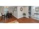 Open-concept dining area with hardwood floors, an adjacent staircase, and plenty of light at 3823 Rock Hollow Ct, Conley, GA 30288