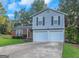 Two-story home with a brick and siding facade, a driveway, and a well-manicured lawn at 3823 Rock Hollow Ct, Conley, GA 30288