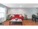 Inviting living room with hardwood floors, a red sofa, and natural light at 3823 Rock Hollow Ct, Conley, GA 30288