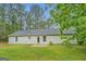 Spacious backyard showcasing a well-maintained lawn, a patio, and the home's exterior at 4547 Atha Cir, Loganville, GA 30052