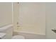 Bathroom area showcasing a white toilet and a bathtub and shower combination with white surround at 4547 Atha Cir, Loganville, GA 30052