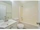Bathroom featuring a tub-shower combination with a white vanity and laminate flooring at 4547 Atha Cir, Loganville, GA 30052