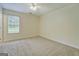 Bedroom with a ceiling fan, a large window, and new carpet at 4547 Atha Cir, Loganville, GA 30052