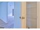 Hallway featuring open linen closet with white wire shelving and hard surface flooring at 4547 Atha Cir, Loganville, GA 30052