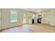 Bright kitchen featuring laminate flooring, white cabinets, and black appliances at 4547 Atha Cir, Loganville, GA 30052