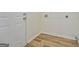 Laundry room with laminate flooring, new trim, and a hookup at 4547 Atha Cir, Loganville, GA 30052