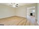 Bright living room with laminate floors, ceiling fan, and open layout into the kitchen area at 4547 Atha Cir, Loganville, GA 30052