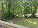 Expansive backyard with lush greenery and mature trees, viewed from the wooden deck, creating a peaceful retreat at 686 Favorwood Sw Dr, Marietta, GA 30060