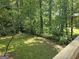 Scenic view from the wooden deck overlooking a private backyard surrounded by lush greenery and mature trees at 686 Favorwood Sw Dr, Marietta, GA 30060