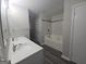 Well-lit bathroom with double vanity, a shower/tub, white cabinets, and modern fixtures at 686 Favorwood Sw Dr, Marietta, GA 30060