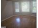 Inviting bedroom with hardwood floors and plenty of natural light from three large windows, creating a serene atmosphere at 686 Favorwood Sw Dr, Marietta, GA 30060