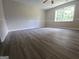 Bright bedroom with neutral paint, wood-look flooring, ceiling fan, and large window at 686 Favorwood Sw Dr, Marietta, GA 30060