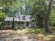 Charming home boasts a welcoming front porch and a well-maintained lawn in a wooded setting at 686 Favorwood Sw Dr, Marietta, GA 30060