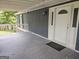 Covered front porch featuring a stylish entrance door and a glimpse of the outdoor scenery, adding curb appeal at 686 Favorwood Sw Dr, Marietta, GA 30060