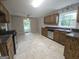 Bright kitchen featuring tile flooring, stainless steel appliances, wooden cabinetry and a window overlooking the yard at 686 Favorwood Sw Dr, Marietta, GA 30060