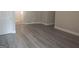 Open living area featuring hardwood floors, crisp white trim and neutral paint, offering a flexible living space at 686 Favorwood Sw Dr, Marietta, GA 30060
