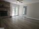 Bright living room features a stone fireplace, hardwood floors, and french doors to a sun-drenched outdoor deck at 686 Favorwood Sw Dr, Marietta, GA 30060