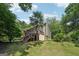 Exterior backyard view of home, with multi-tiered deck and lawn at 10875 Shagbark Trl, Roswell, GA 30075