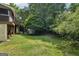 Backyard featuring a shed, multilevel deck and a lot of trees at 10875 Shagbark Trl, Roswell, GA 30075