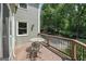 Backyard patio featuring a table and chairs with wooded view at 10875 Shagbark Trl, Roswell, GA 30075