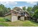 Spacious multi-level deck with hot tub and landscaped yard at 10875 Shagbark Trl, Roswell, GA 30075