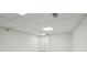 Clean basement features neutral carpeting, white walls, and a drop ceiling with recessed lighting at 10875 Shagbark Trl, Roswell, GA 30075