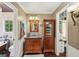 Bathroom with hardwood floors, wood vanity, storage cabinet, tub and a view of walk-in closet at 10875 Shagbark Trl, Roswell, GA 30075