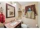 Bathroom features a granite countertop, framed mirror and decorative window coverings at 10875 Shagbark Trl, Roswell, GA 30075