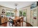 Dining room features hardwood floors, backyard views and chandelier lighting at 10875 Shagbark Trl, Roswell, GA 30075