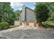 Charming home with a two-car garage, deck, and mature trees creating a private driveway at 10875 Shagbark Trl, Roswell, GA 30075