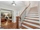 Foyer featuring hardwood staircase, with views to the office and living areas at 10875 Shagbark Trl, Roswell, GA 30075