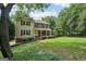 Charming two-story home with a welcoming front porch and a well-manicured lawn at 10875 Shagbark Trl, Roswell, GA 30075
