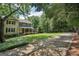 Charming two-story home with a welcoming front porch and a well-manicured lawn at 10875 Shagbark Trl, Roswell, GA 30075