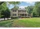 Charming two-story home with a welcoming front porch and a well-manicured lawn at 10875 Shagbark Trl, Roswell, GA 30075