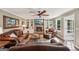 Bright living room showcasing a brick fireplace, built-in shelves, and comfortable leather seating at 10875 Shagbark Trl, Roswell, GA 30075