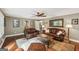 Cozy living room featuring leather sofas, a decorative mirror, and hardwood flooring at 10875 Shagbark Trl, Roswell, GA 30075