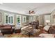 Comfortable living room with a wooden fan, leather seating, and access to an outdoor space at 10875 Shagbark Trl, Roswell, GA 30075