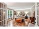 Bedroom with neutral tones, hardwood floors and large window with natural light at 10875 Shagbark Trl, Roswell, GA 30075