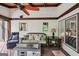 Comfortable screened porch showcasing ceiling fan, stylish seating, and a modern fire pit at 10875 Shagbark Trl, Roswell, GA 30075