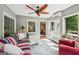 Relaxing sunroom with plentiful natural light, views of the yard, and comfortable seating at 10875 Shagbark Trl, Roswell, GA 30075