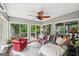 Bright sunroom with multiple windows offering views of the outdoor deck and lush greenery at 10875 Shagbark Trl, Roswell, GA 30075