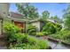 Charming home featuring a well-maintained yard with lush landscaping and a brick entryway at 1977 Kensington High Sw St, Lilburn, GA 30047