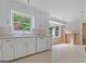 Bright kitchen features white cabinets, a window, and a view of the outdoors at 1977 Kensington High Sw St, Lilburn, GA 30047