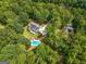 Overhead view of a home nestled in lush greenery featuring a swimming pool and a spacious well-manicured yard at 607 Lees Mill Rd, Fayetteville, GA 30214