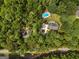Aerial view of a wooded property showcasing a private pool and well-maintained home surrounded by lush greenery at 607 Lees Mill Rd, Fayetteville, GA 30214
