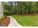 Beautifully landscaped backyard with a well-maintained lawn and mature trees at 607 Lees Mill Rd, Fayetteville, GA 30214