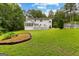 Spacious backyard featuring a large white house, patio, and lush green lawn at 607 Lees Mill Rd, Fayetteville, GA 30214