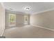 Neutral bedroom with carpet flooring features two windows bringing in lots of light at 607 Lees Mill Rd, Fayetteville, GA 30214
